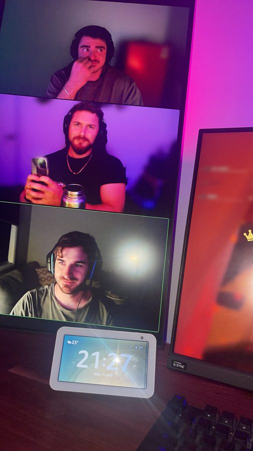 Three friends on a video call shown on a monitor