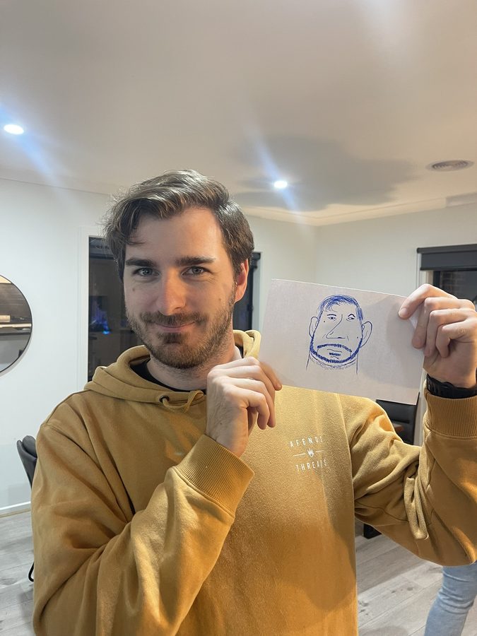 Jye holding a portrait of himself